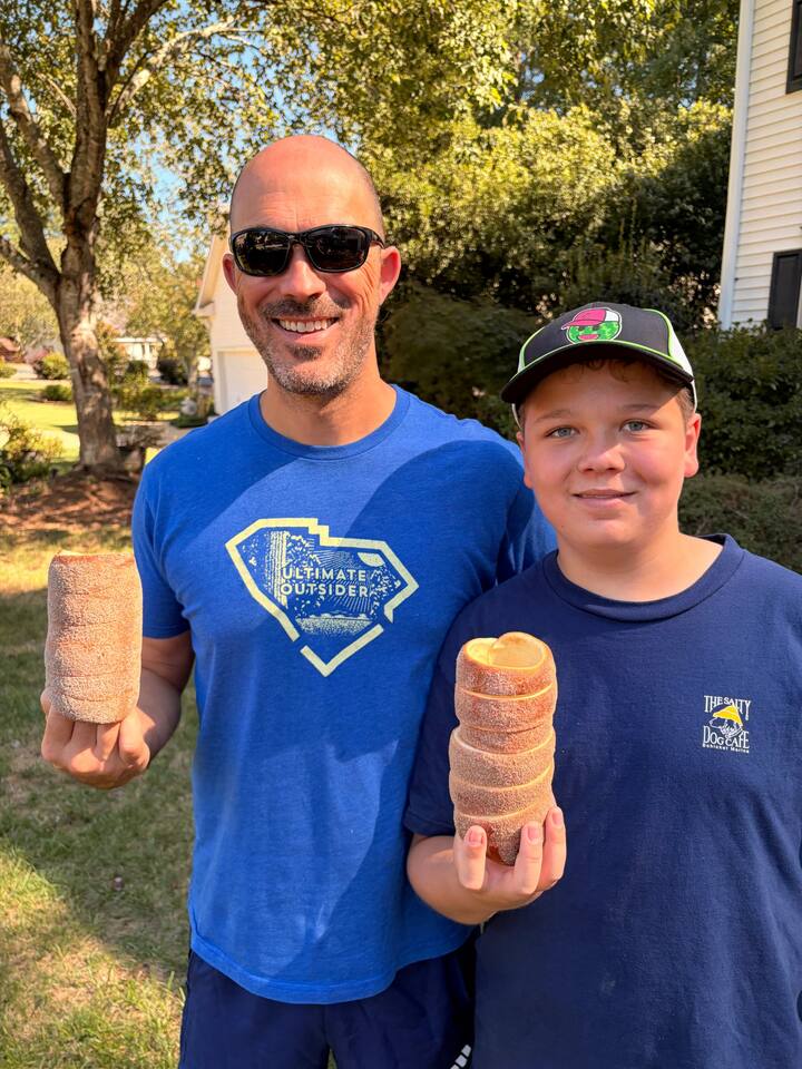 Neal and Caleb each holding a fresh chimney cake