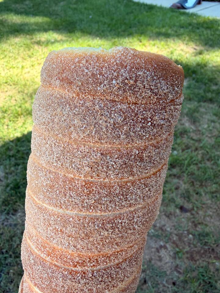 Close-up of a crackling cinnamon-sugar chimney cake crust